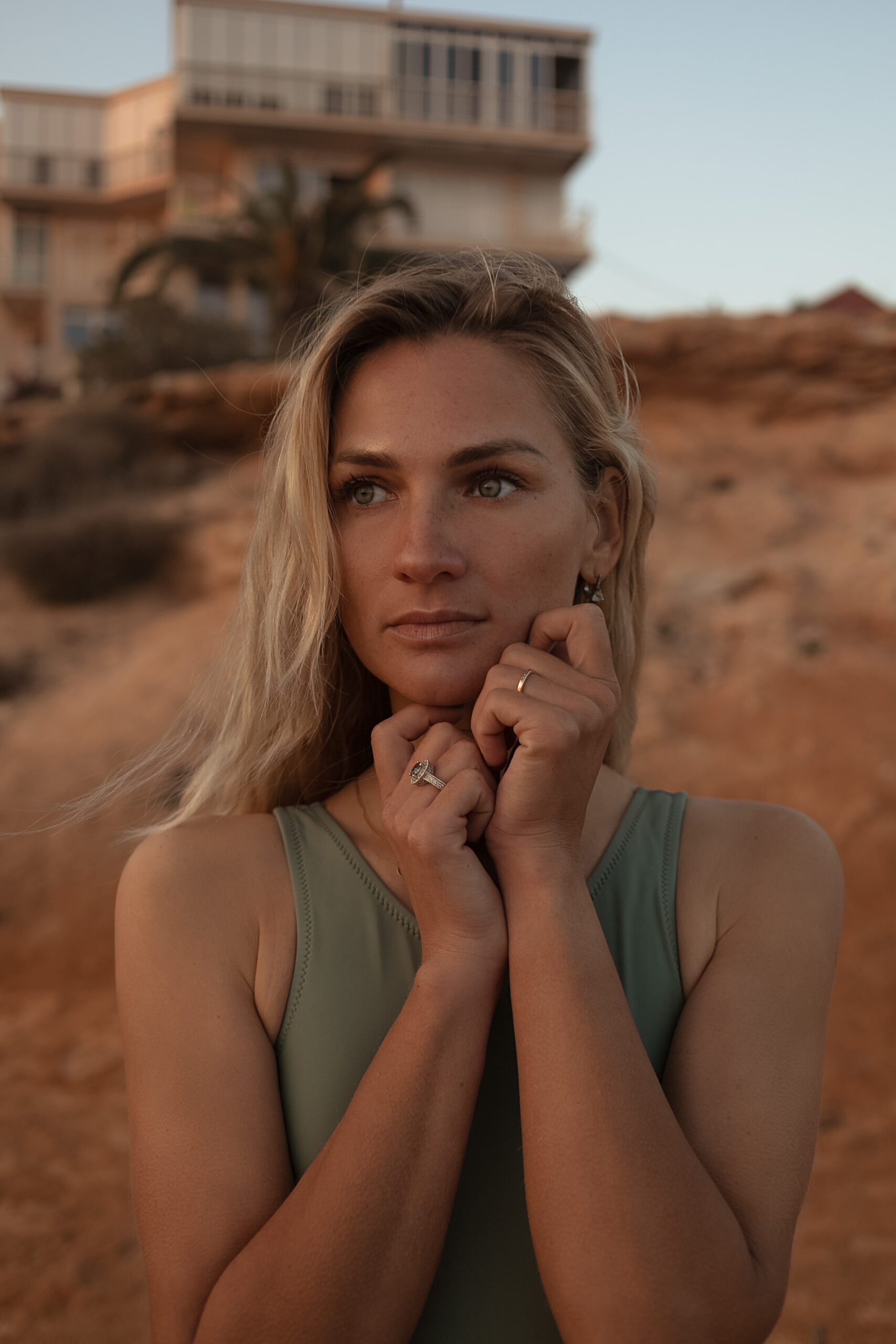 Blond woman with green eyes wearing nice jewellery  